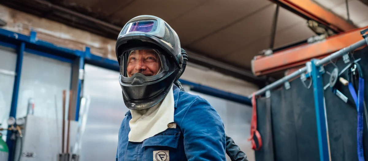 Apprenticeship and career at Fassmer – welder in protective gear working in shipbuilding